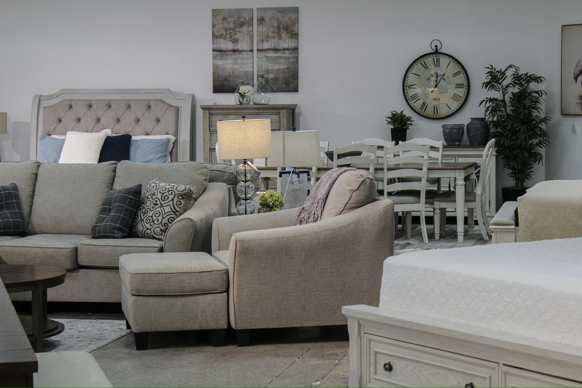 Ashley Furniture showroom with coordinated bedroom and living room displays