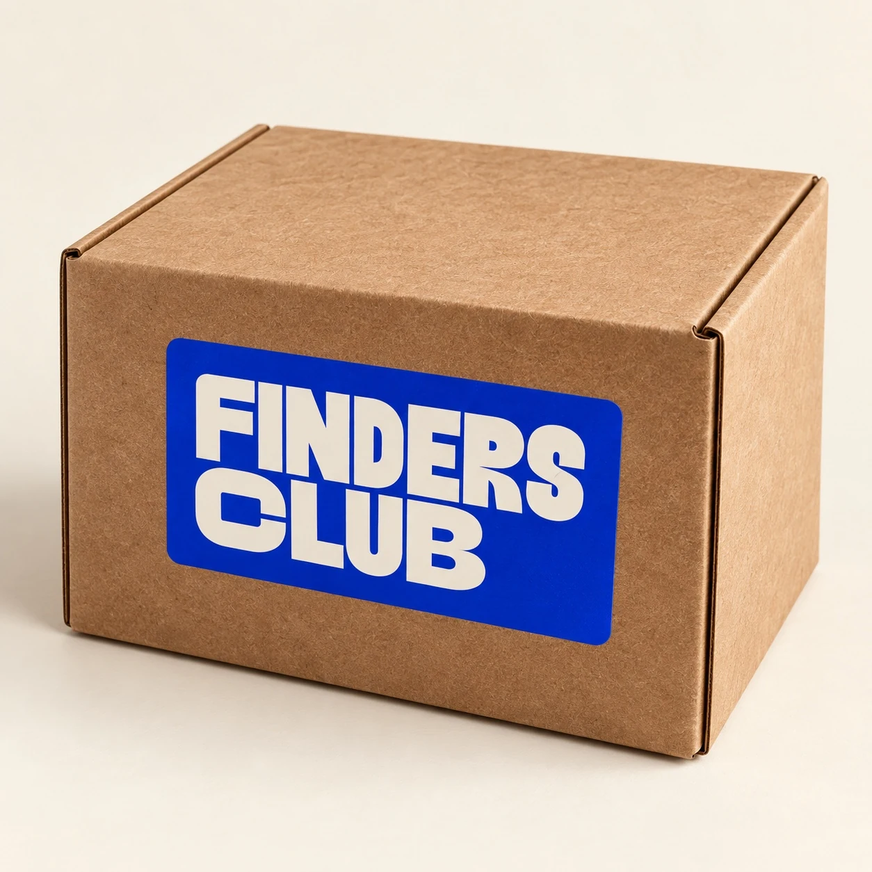 Cardboard shipping box with a blue Finders Club label